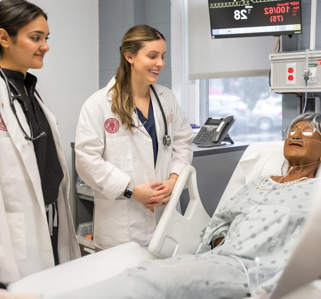 Nursing students working on model patient